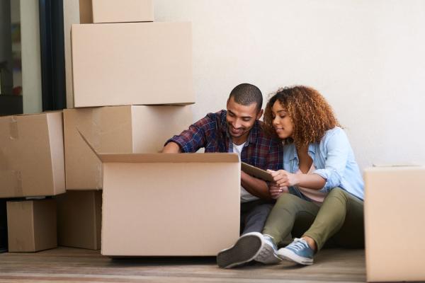 Young couple unpacking a box after moving