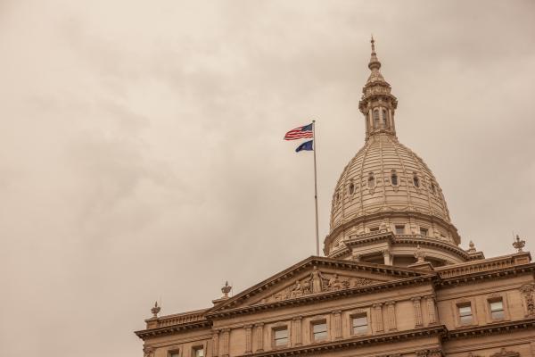 Michigan Capitol building dome amid a gray cloudy sky