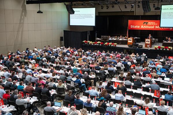 Wide overhead shot of the packed delegate floor of the 2024 Michigan Farm Bureau State Annual Meeting.