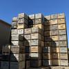 Towers of full apple bins against a bright blue sky at Schweitzer Orchards in Sparta, Michigan.